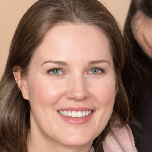 Joyful white young-adult female with medium  brown hair and grey eyes