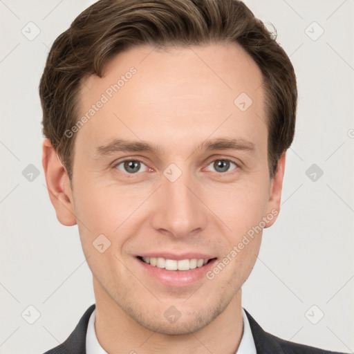 Joyful white young-adult male with short  brown hair and grey eyes