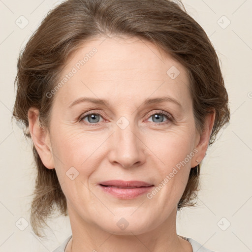 Joyful white adult female with medium  brown hair and grey eyes