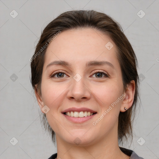 Joyful white young-adult female with medium  brown hair and grey eyes