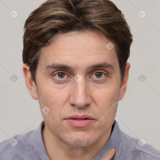 Joyful white adult male with short  brown hair and grey eyes