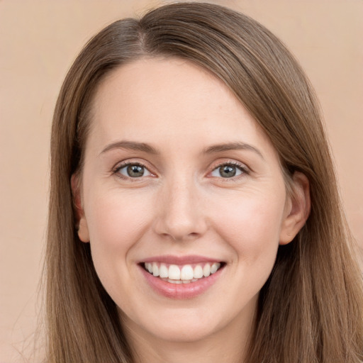 Joyful white young-adult female with long  brown hair and grey eyes