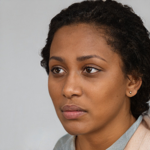 Neutral black young-adult female with short  brown hair and brown eyes