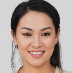 Joyful asian young-adult female with medium  brown hair and brown eyes