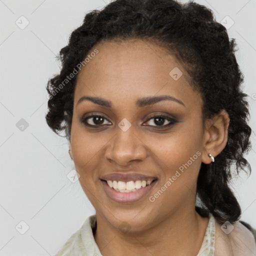 Joyful black young-adult female with long  brown hair and brown eyes