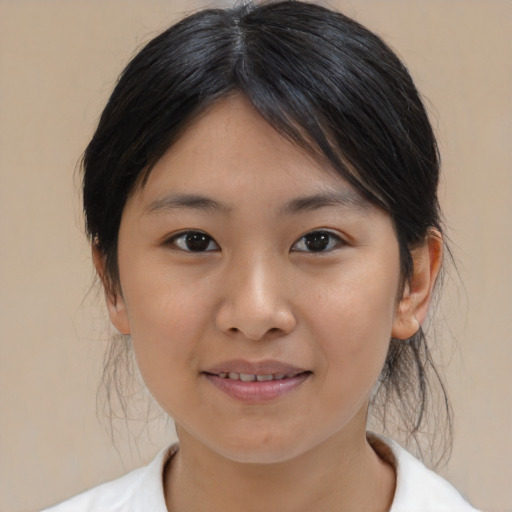 Joyful asian young-adult female with medium  brown hair and brown eyes