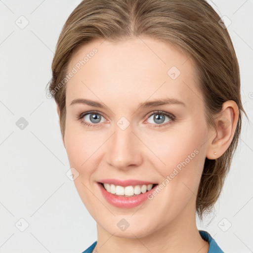 Joyful white young-adult female with medium  brown hair and blue eyes