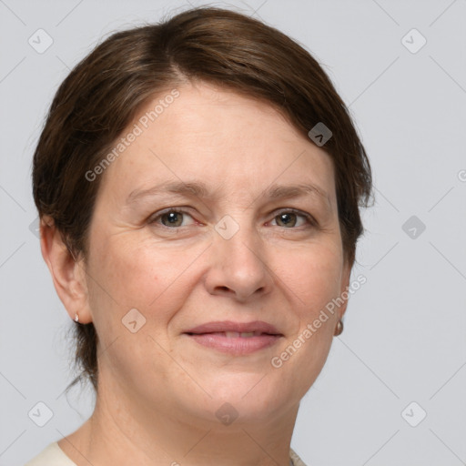 Joyful white adult female with medium  brown hair and grey eyes