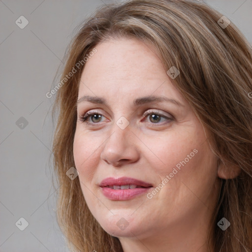 Joyful white adult female with long  brown hair and brown eyes