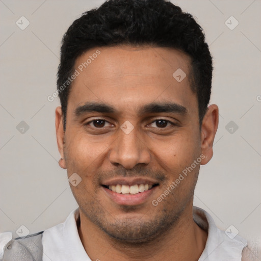 Joyful latino young-adult male with short  black hair and brown eyes