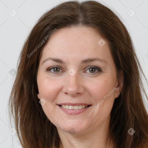 Joyful white adult female with long  brown hair and brown eyes