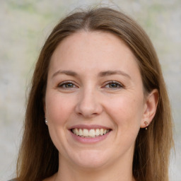 Joyful white adult female with long  brown hair and grey eyes