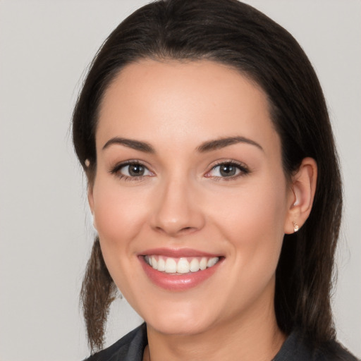 Joyful white young-adult female with medium  brown hair and brown eyes