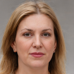 Joyful white adult female with medium  brown hair and grey eyes