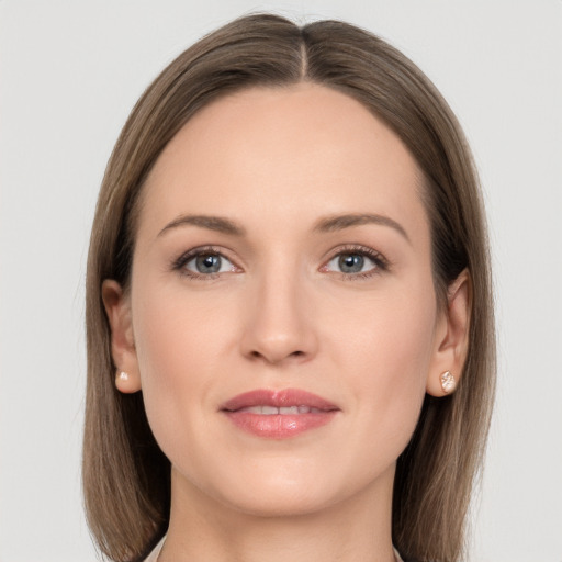 Joyful white young-adult female with long  brown hair and grey eyes