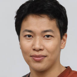 Joyful asian young-adult male with short  black hair and brown eyes