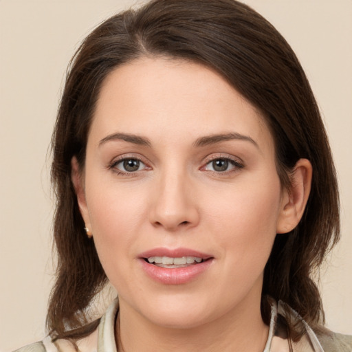 Joyful white young-adult female with medium  brown hair and brown eyes