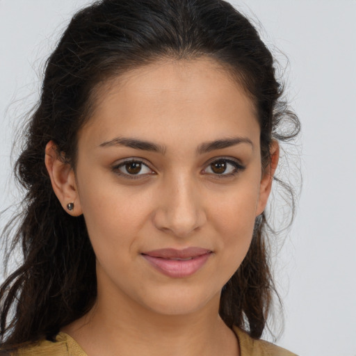 Joyful latino young-adult female with medium  brown hair and brown eyes