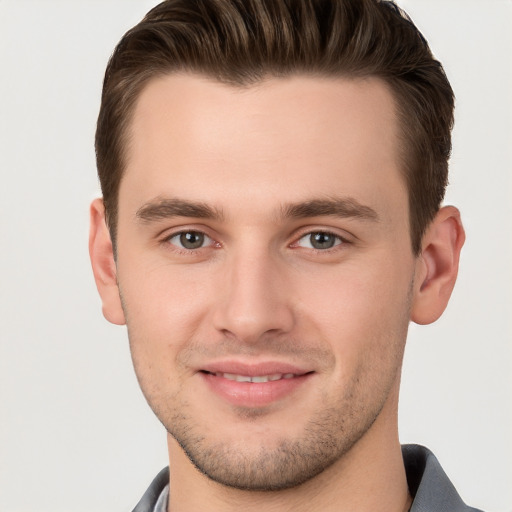 Joyful white young-adult male with short  brown hair and brown eyes