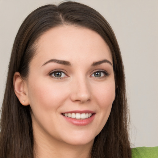 Joyful white young-adult female with long  brown hair and grey eyes