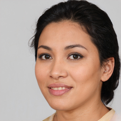 Joyful latino young-adult female with medium  black hair and brown eyes