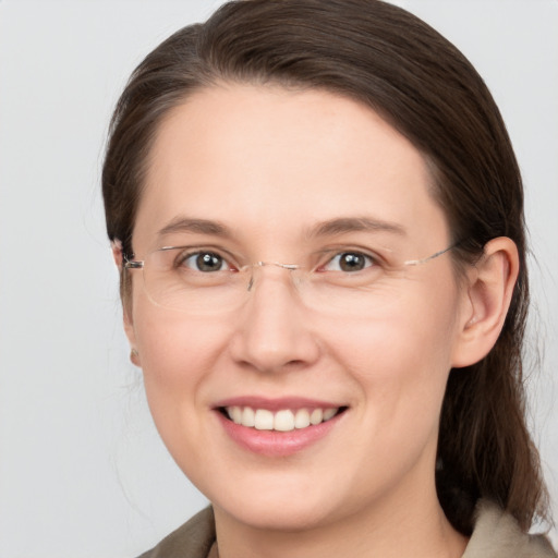 Joyful white young-adult female with medium  brown hair and grey eyes