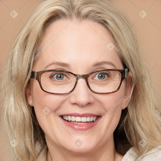 Joyful white adult female with medium  brown hair and blue eyes