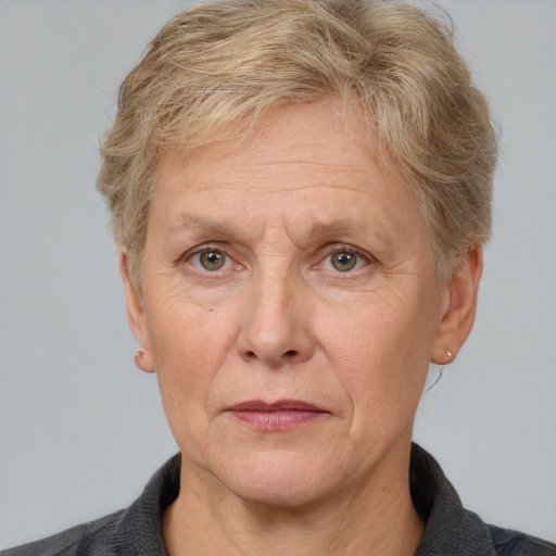 Joyful white middle-aged female with short  brown hair and grey eyes