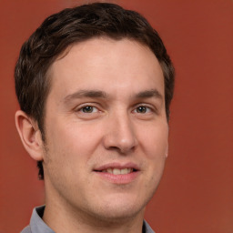 Joyful white adult male with short  brown hair and brown eyes