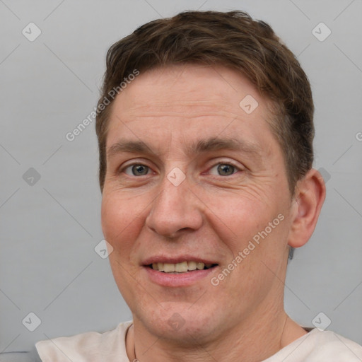 Joyful white adult male with short  brown hair and brown eyes