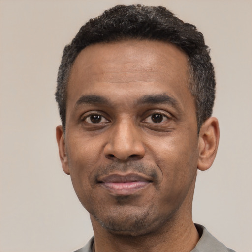 Neutral latino adult male with short  black hair and brown eyes