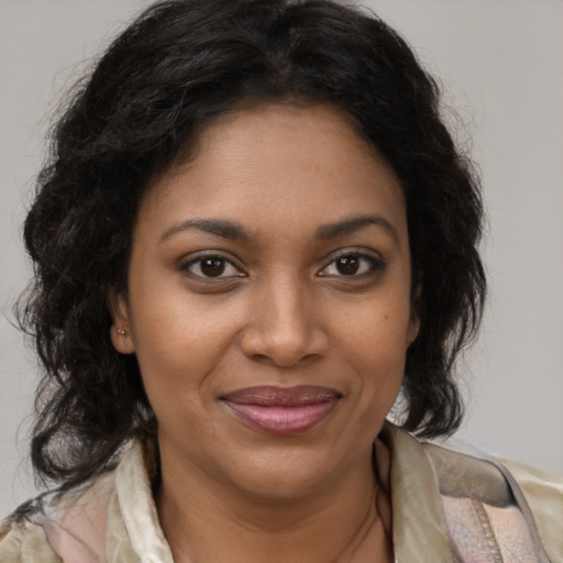 Joyful black young-adult female with medium  brown hair and brown eyes