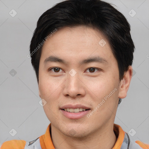 Joyful asian young-adult male with short  brown hair and brown eyes