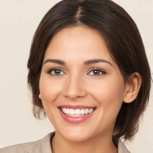 Joyful white young-adult female with medium  brown hair and brown eyes