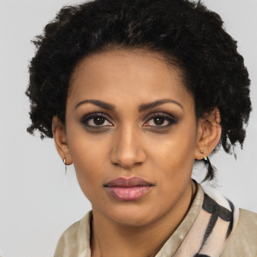 Joyful black young-adult female with long  brown hair and brown eyes