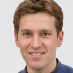 Joyful white adult male with short  brown hair and grey eyes