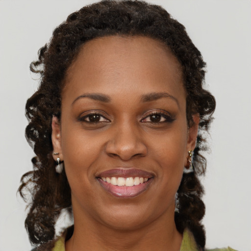 Joyful black young-adult female with medium  brown hair and brown eyes