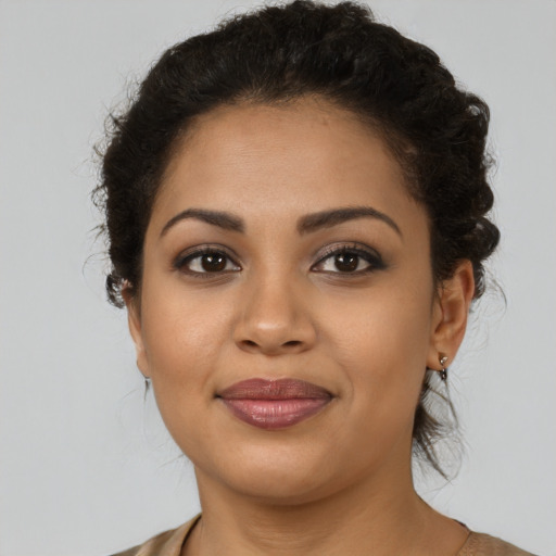 Joyful latino young-adult female with short  brown hair and brown eyes