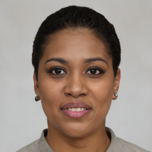 Joyful black young-adult female with short  black hair and brown eyes
