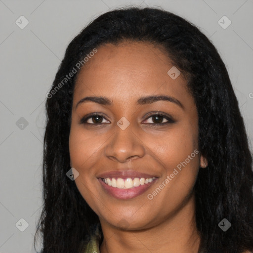 Joyful black young-adult female with long  black hair and brown eyes