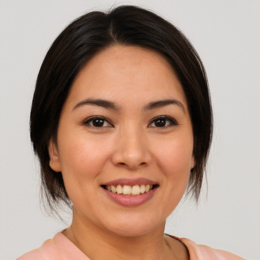 Joyful asian young-adult female with medium  brown hair and brown eyes