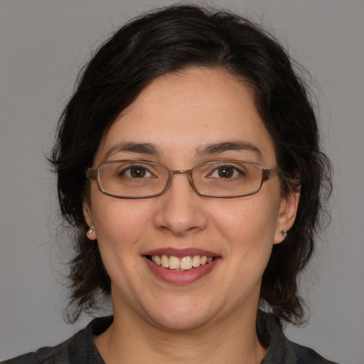 Joyful white adult female with medium  brown hair and brown eyes