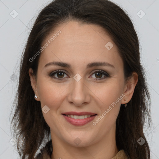 Joyful white adult female with long  brown hair and brown eyes