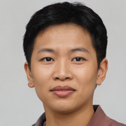 Joyful asian young-adult male with short  black hair and brown eyes