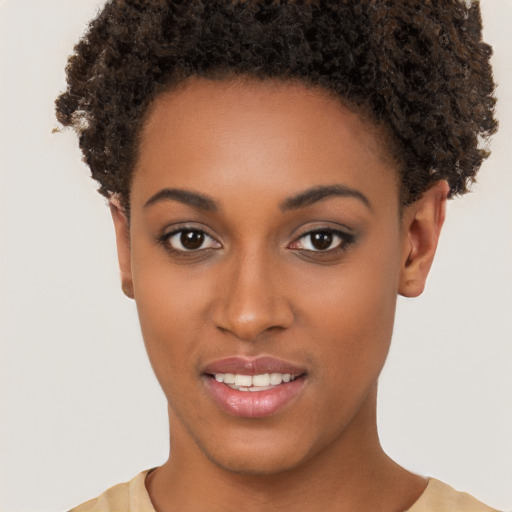 Joyful black young-adult female with short  brown hair and brown eyes