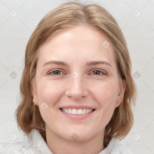 Joyful white young-adult female with medium  brown hair and blue eyes