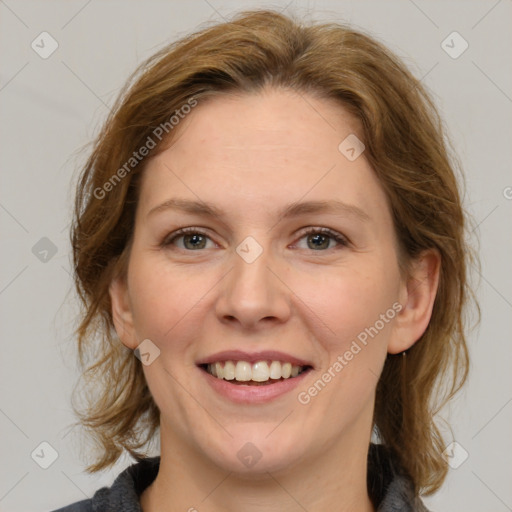 Joyful white adult female with medium  brown hair and grey eyes