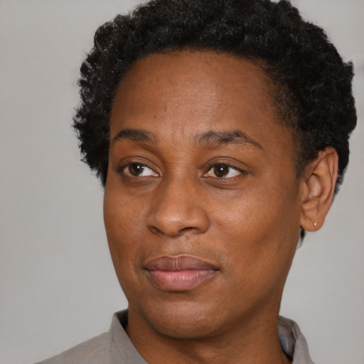 Joyful black adult female with short  brown hair and brown eyes