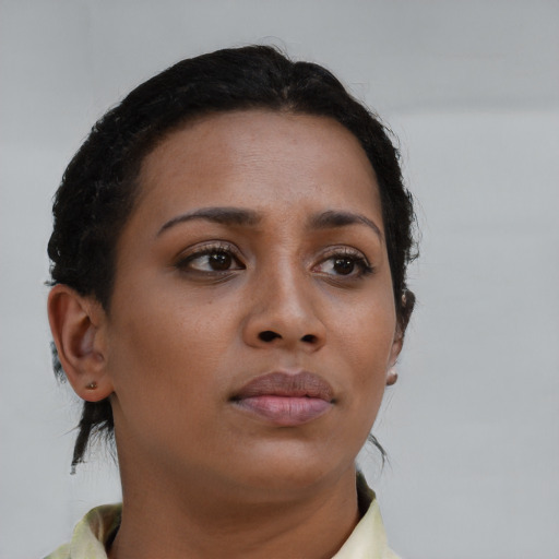 Neutral black young-adult female with medium  brown hair and brown eyes