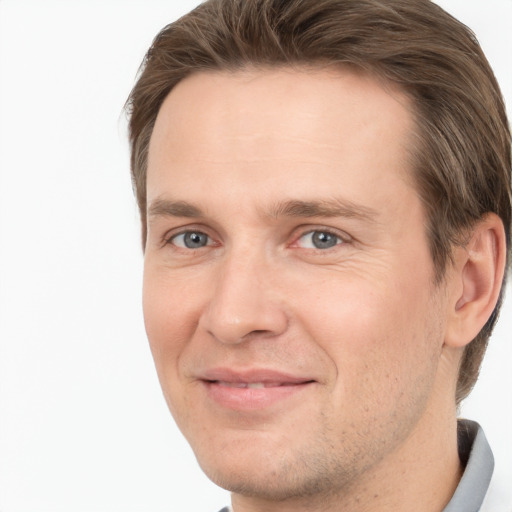 Joyful white adult male with short  brown hair and grey eyes